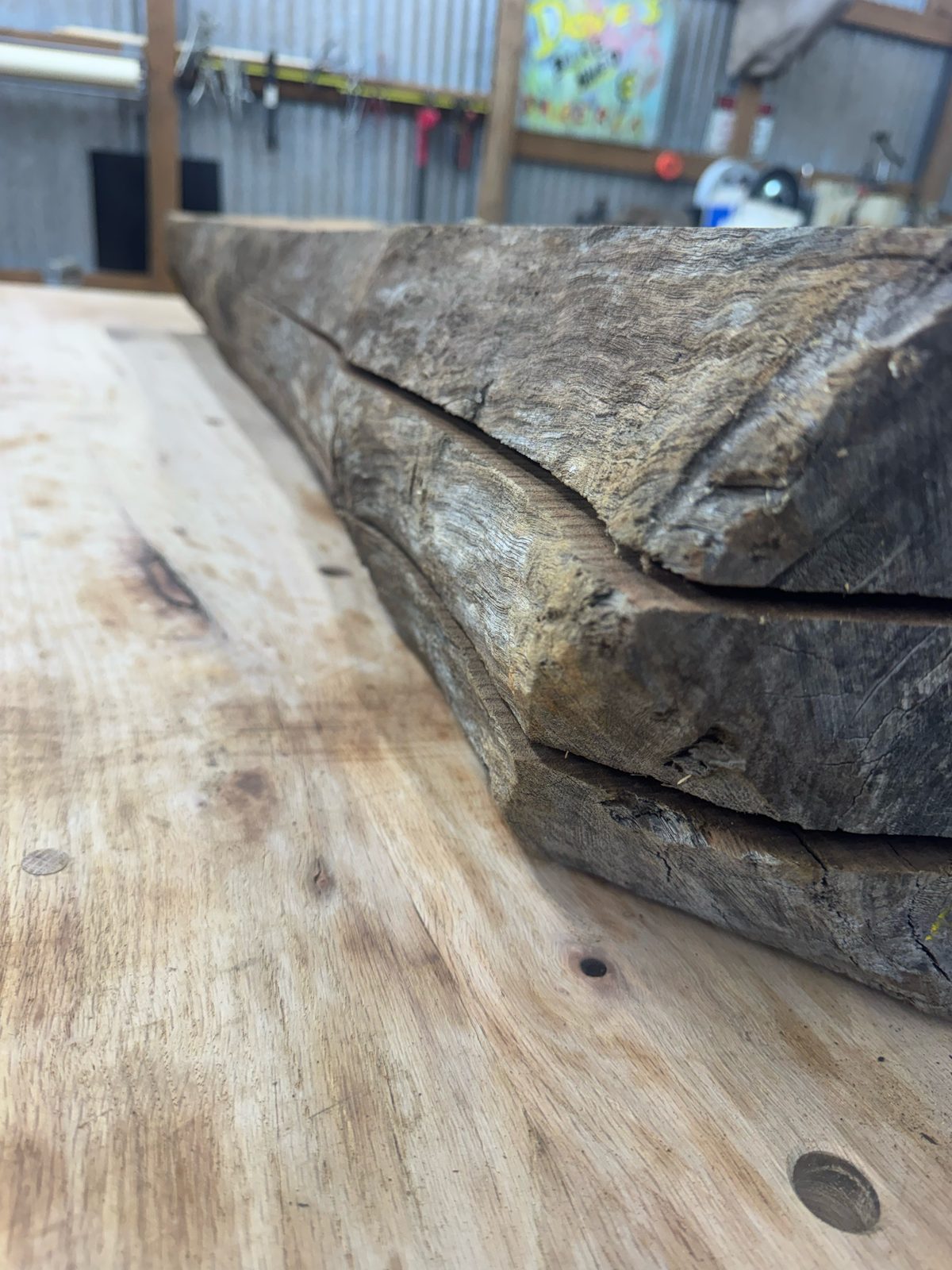 Three stacked rough-sawn walnut flitches with live edges, lot BW003