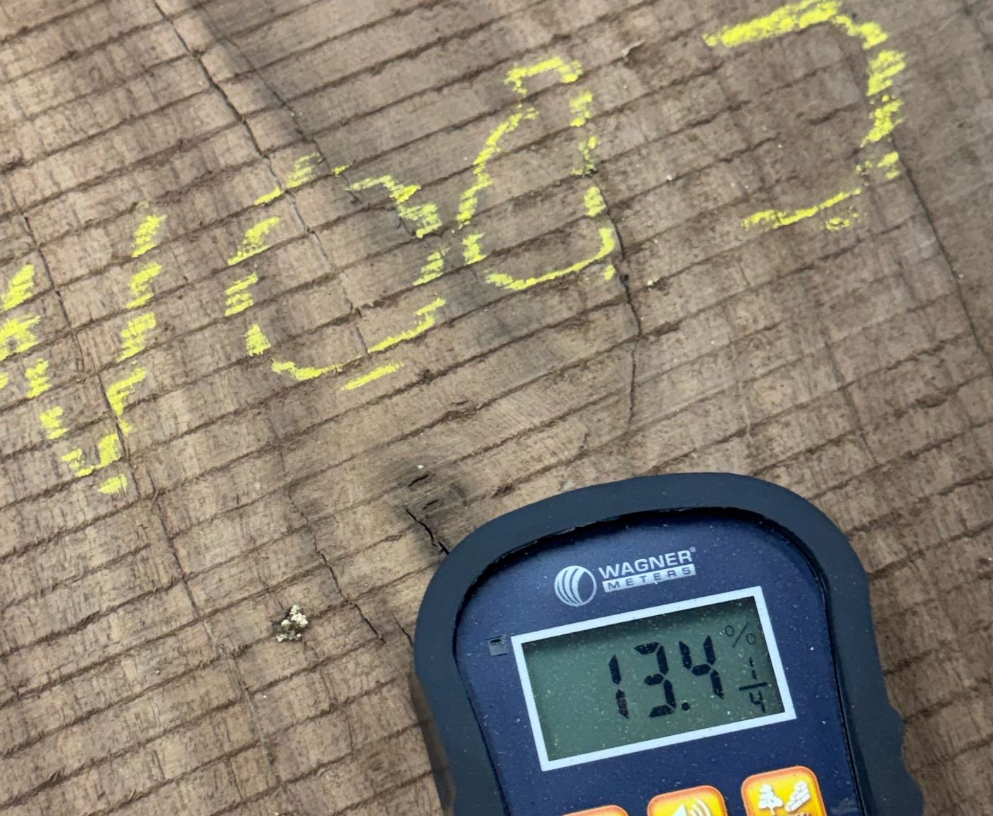 Moisture meter reading 13.4 percent on a flitch chalk-marked BW003