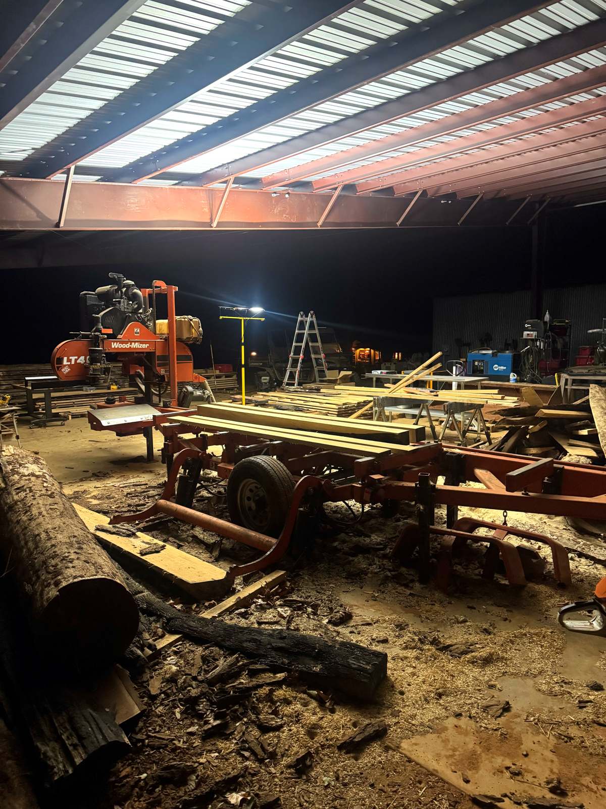 The mill shed, logs and welder