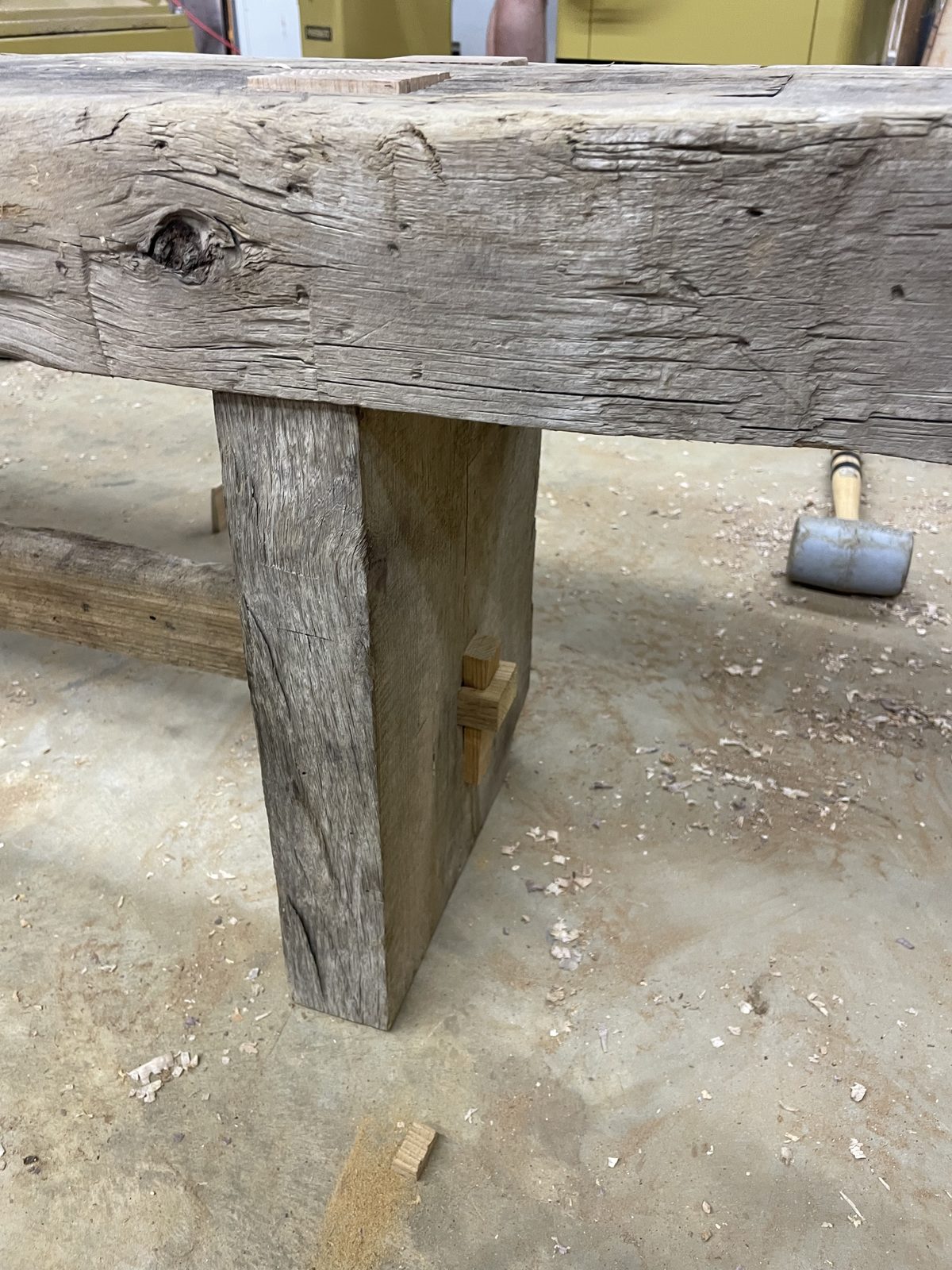 Rustic timber bench leg with a wedged through-tenon